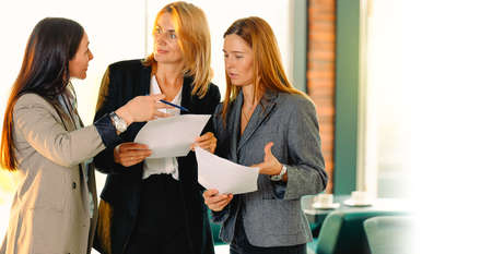 Portrait of three friends developing steps in business career. Talk speak company showing proposition tips action read check account contract agreement building team concept.の写真素材