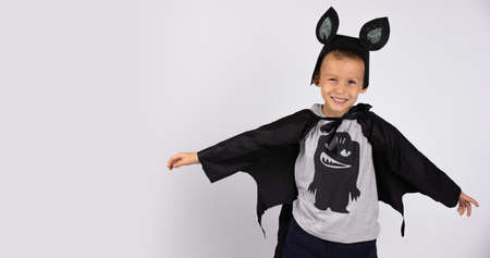 Cute bat smiling and happy preparing for Halloween Happy Halloween. Handsome caucasian kindergarden boy. Photo on a white background. High quality photoの写真素材
