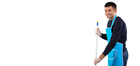 Banner, long format. A man in an apron mops the floor with a mop and smiles at the camera. Photo on white background with empty side space. High quality photoの写真素材