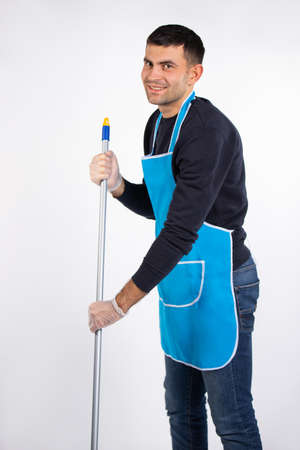 A man wipes the floor with a mop. Gender stereotypes. White background.の写真素材