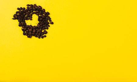 Coffee beans in the shape of a heart on a illuminating background with empty space where your ad could be. St Valentines. High quality photoの写真素材
