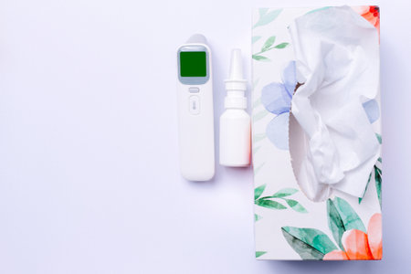 Disposable wipes, nasal spray and non-contact thermometer. Cold and virus concept. White background and side space.の写真素材