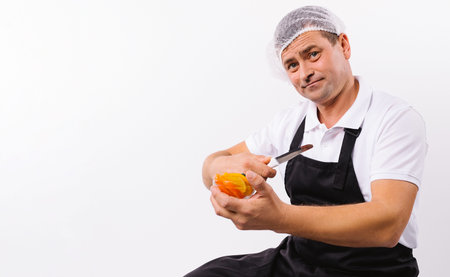 Banner. A portrait of a man in a black apron with a bowl and a knife in his hands looks at the...