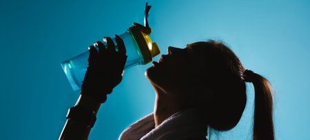 Banner, long format. Blacked-out portrait of a girl with long hair who drinking water against on...