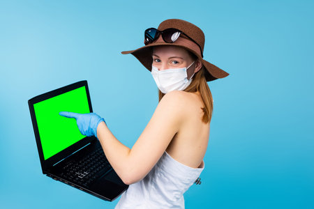 Summer woman in medical disposable mask, gloves points at advertisement, greeen mockup computer pc,...