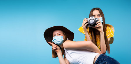 Banner,long format. Happy female friends taking pictures and posing in summer clothes, hat and...