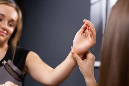 The concept of mental health PTSD, psychologist sitting and touching the hand of the depressed young lady for encouragement near the window with poor environment.の写真素材