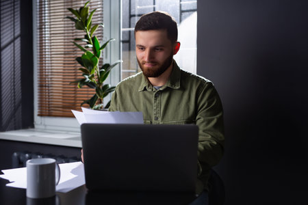 The image of a young entrepreneur or manager carefully analyzing the rate of increase or decrease in...