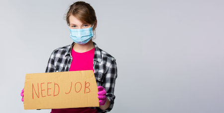 The concept of the need to find a job in a critical period of a pandemic. Young housemaid with mask...