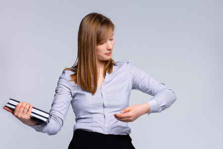 A young woman sitting on a ladder, meditating on a choice between a busy business career or a family lifestyle and maternity. Education or marriage. High quality photoの写真素材