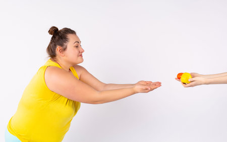 Obese woman isolated on white backround, wearing t-shirt , ready to drop extra pounds, happily...