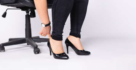 Banner,long format. Womens plump legs in black shoes on a white background with space for text or advertising of womens shoes.の写真素材