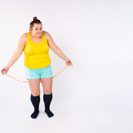 Diet restriction and stress concept. Portrait of young frustrated caucasian woman with beige...