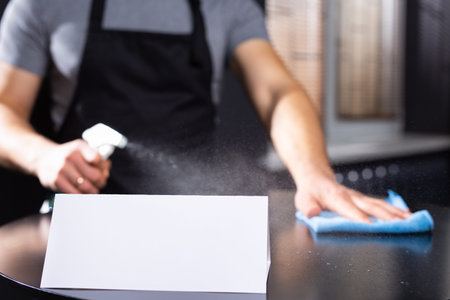 Male cleaning. isease prevention. Disinfectant spray, wipes of desk at home or workplace for safety....