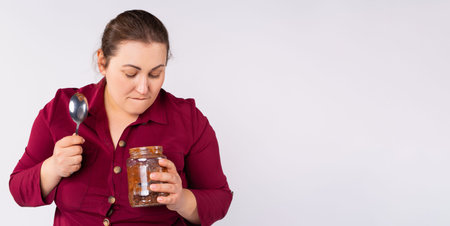 Banner,long format. The large woman is built up as she ate the whole can of chocolate paste. Obesity and diabetes mellitus.の写真素材