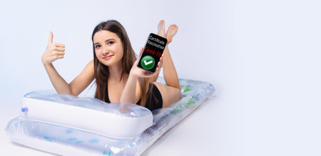 Banner, long format. A young girl is holding a mobile phone with a mock-up of a digital certificate...