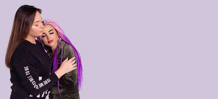 Support for girlfriend, embracing affectionately. Meeting people in love on a gray background. High quality photoの写真素材