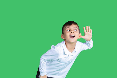 A boy is listening something with an ear. He is paying attention. Listening every word. White shirt...