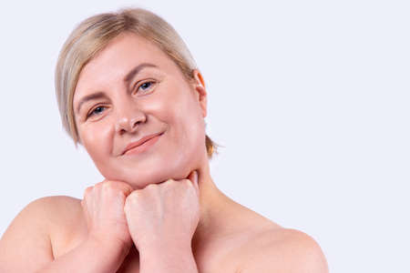 Close up photo of beautiful amazing mature lady overjoyed after salon spa procedures with smiling on her face. High quality photoの写真素材