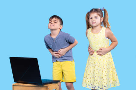 Children are examined online by a doctor due to abdominal pain, because they look very badly and they need medical help.の写真素材