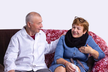 The doctor man came to see his patient woman to make sure she takes medication at the appointed time.の写真素材