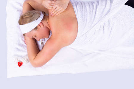 Relaxed caucasian woman receiving a health treatment in a spa center for health maintain.の写真素材