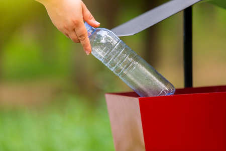 Close up photo of a garbage can in the street or in the park where all people must through the plastic bottle or another rubbish to divide it into garbage containers.の写真素材