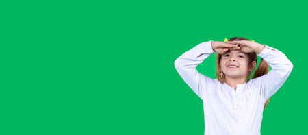 Young girl girl in white t-shirt posing isolated in studio holding hand at forehead looking far away distanceの写真素材