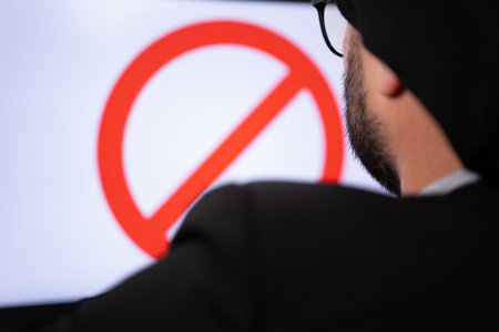 Close portrait of muslim hacker who is banned online sitting on the computer.の写真素材