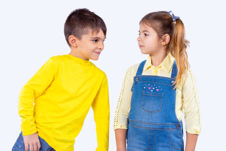 Smart good looking boy leaned over to the girl and wants to say several words to her and she is very attentive.の写真素材