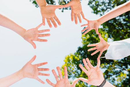 Picture from above of the people hands turned with their palms in the circle towards the camera, they are united in support of freedom from the virus, pandemic concept.の写真素材