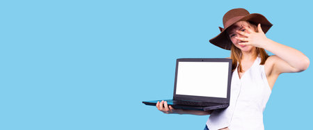 Pretty young woman wearing the brown hat and white top holding computer in the one hand and covers...