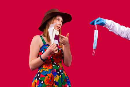 Pretty woman in a color dress wearing cowboy hat pointing at the vaccination passport and does not...