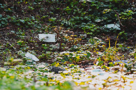 Picture of medical masks used lying down on the ground, concept save planet earth and keep it clean on pandemic time.の写真素材