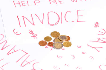 Close up photo of coins on the paper with inscription of payments invoices in business crisis concept.の写真素材