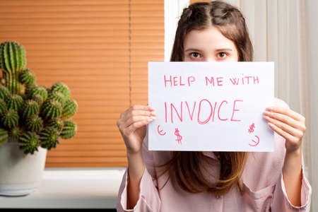 Young woman asking for help suffering stress doing domestic accounting paperwork bills and invoices, payment concept.の写真素材