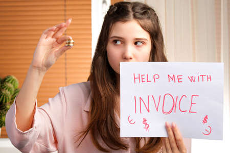Young attractive sad and desperate business woman asking for help with invoice and looking at her hand with coins.の写真素材
