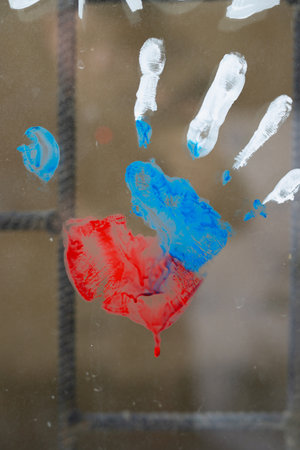 Photo of a handprint on window with bars of russian flag to support nation and be united, people must live in peace concept.の写真素材
