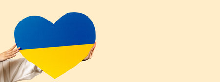 Banner. Cardboard heart the colors of the Ukrainian flag, isolated on the background. A call for peace and an end to the war. No war, stop war.の写真素材