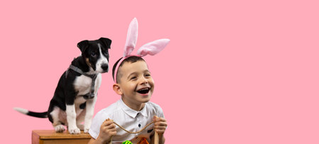 Picture of a smiling boy wearing bunny ears holding basket with painted eggs and his lovely dog...