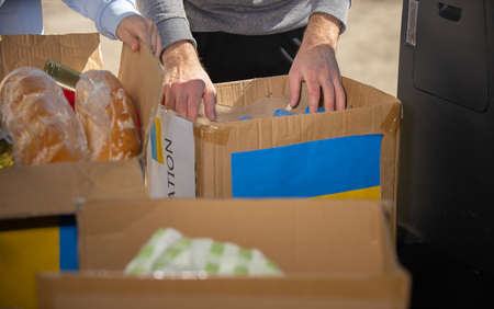 Group of volunteers starting their work with donations for Ukrainian refugees all the necessary things for survival, humanitarian aid concept.の写真素材