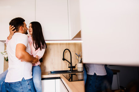 Happy couple in love standing in the kitchen romantically. Big love in their eyes.の写真素材