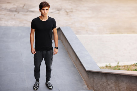 City portrait of man wearing black t-shirt. Mockup for printing.の写真素材