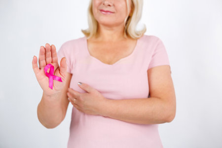 Womaen hand holding pink ribbon breast cancer awareness. Concept healthcare and medicine.の写真素材