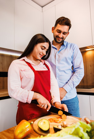 Portrait young couple smiling and hugging in the kitchen great time together in the kitchen at home. Couple life concept.の写真素材