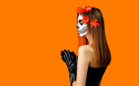 Sexy halloween woman witch on orange studio background .の写真素材