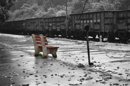 selective colour image of a chair in a railway stationの写真素材