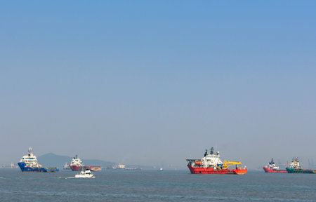 A orange rescue boat floating in the vast blue water