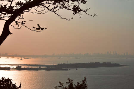 Sunset near a ocean with reddish sky near a portの写真素材