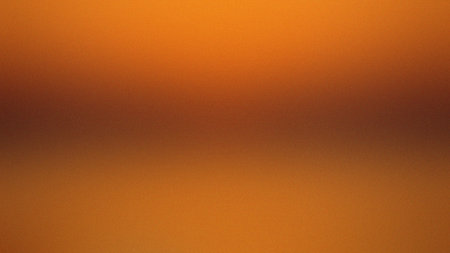 Smooth gradient of warm orange and brown tones with a subtle grain texture. Clear details and vib...の写真素材